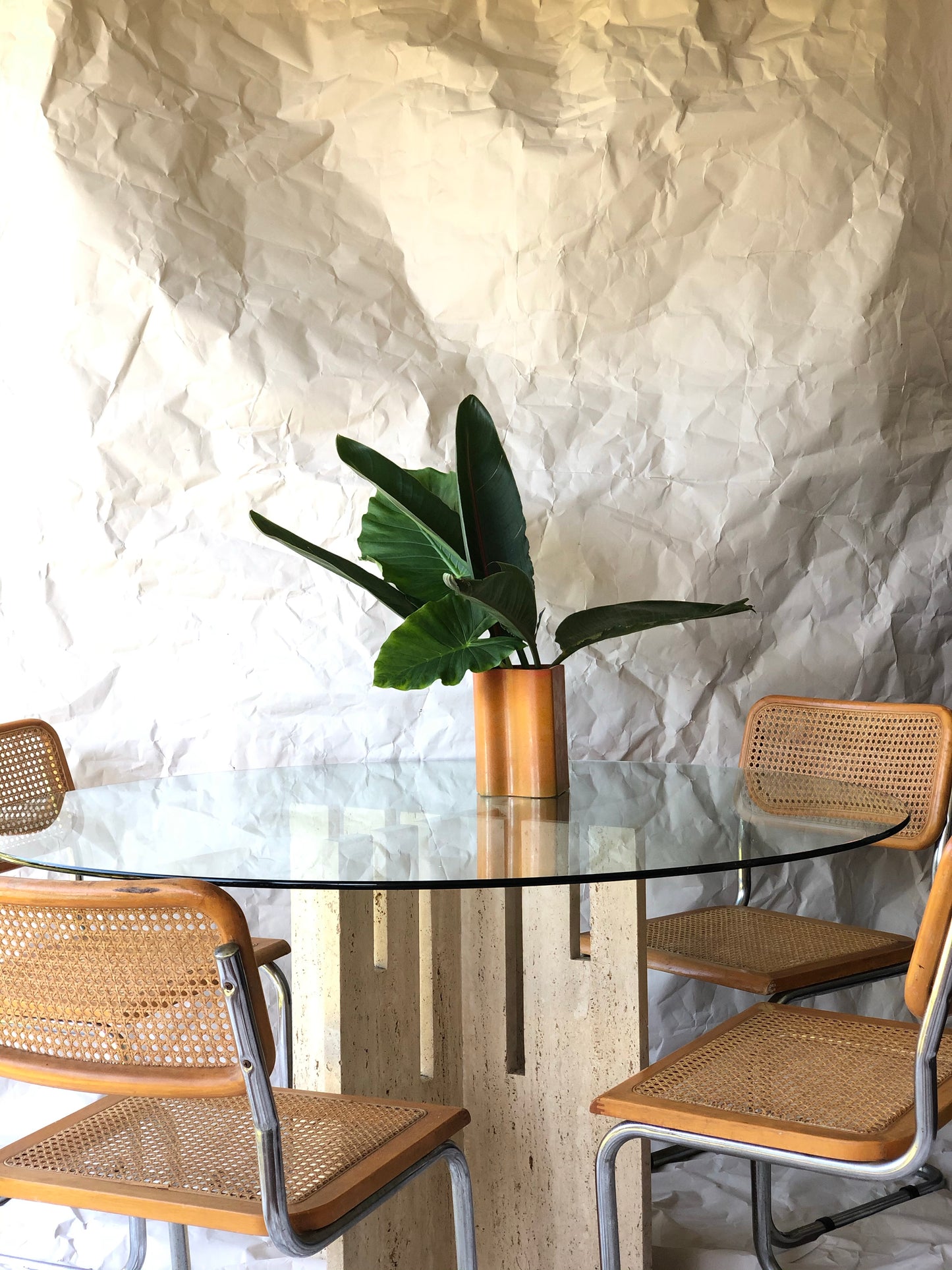 Unfilled travertine dining table with glass top
