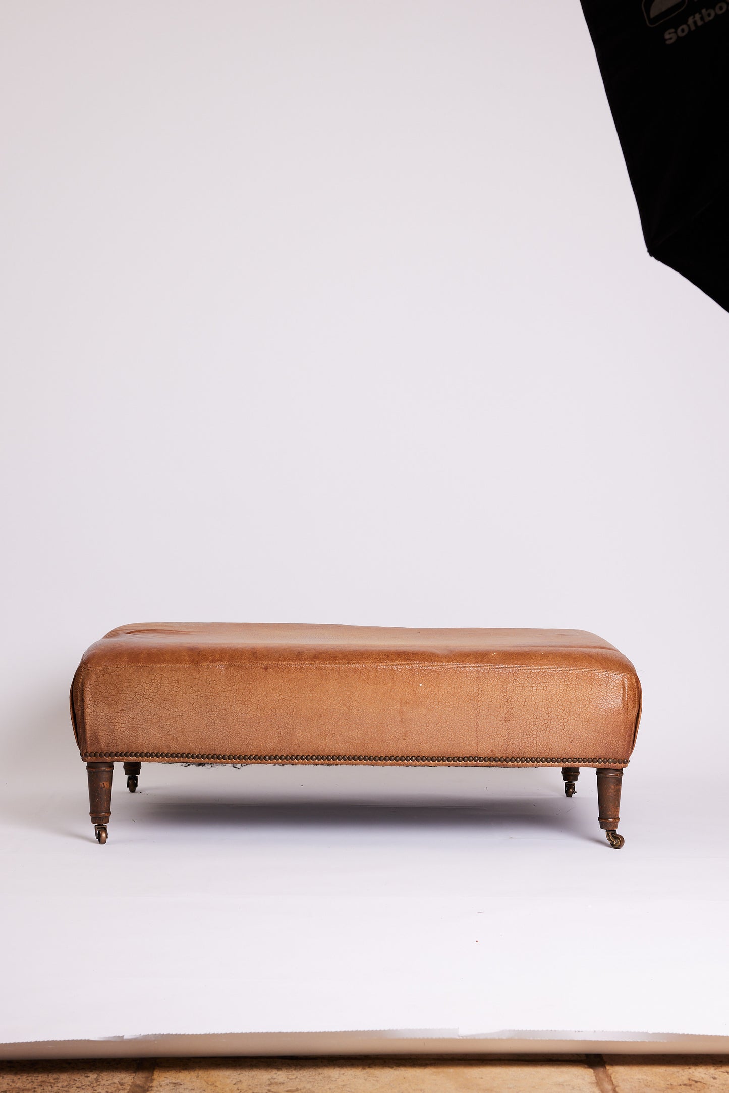 Leather Ottoman with Turned Legs & Castors