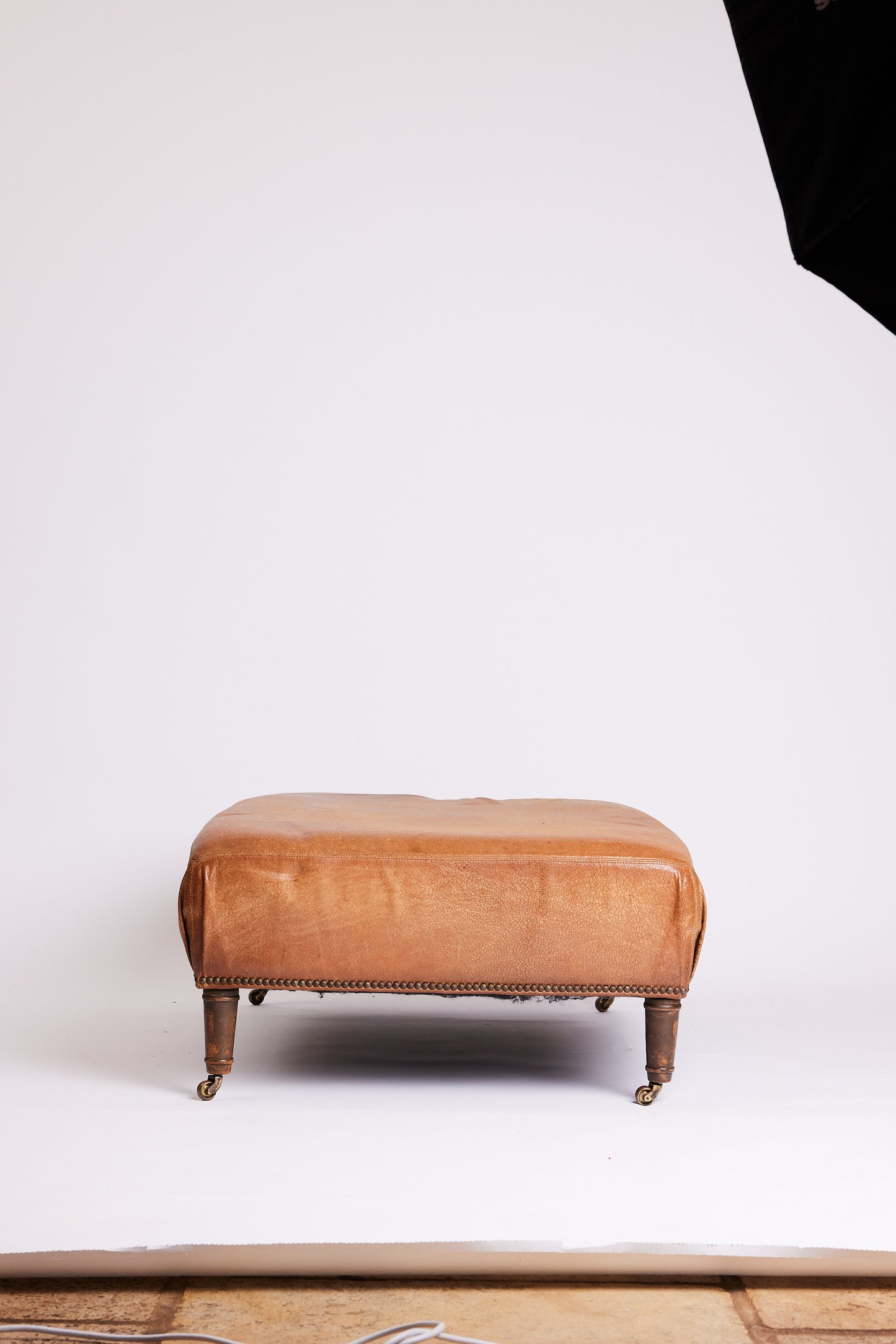 Leather Ottoman with Turned Legs & Castors