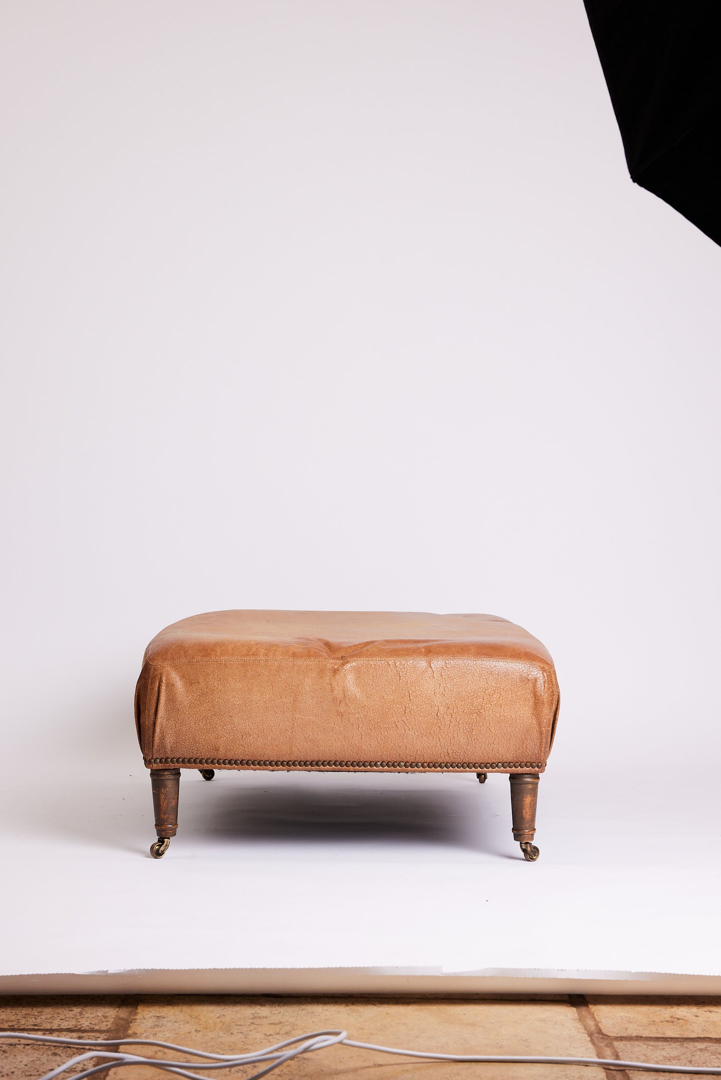 Leather Ottoman with Turned Legs & Castors