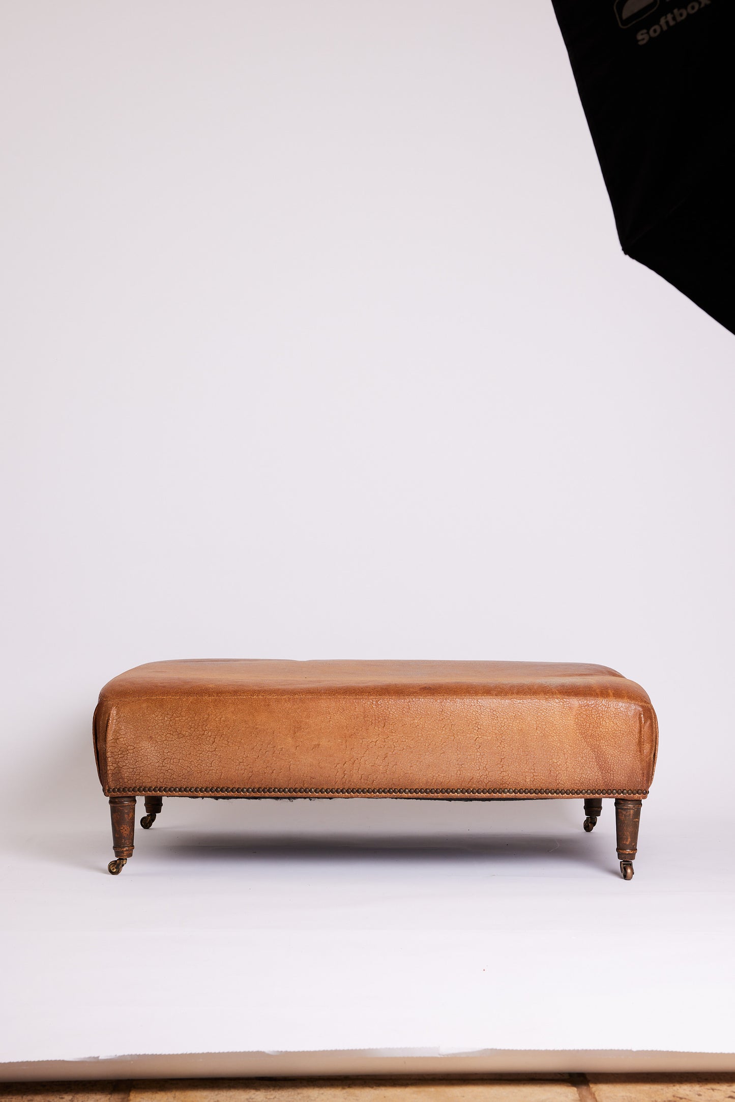 Leather Ottoman with Turned Legs & Castors
