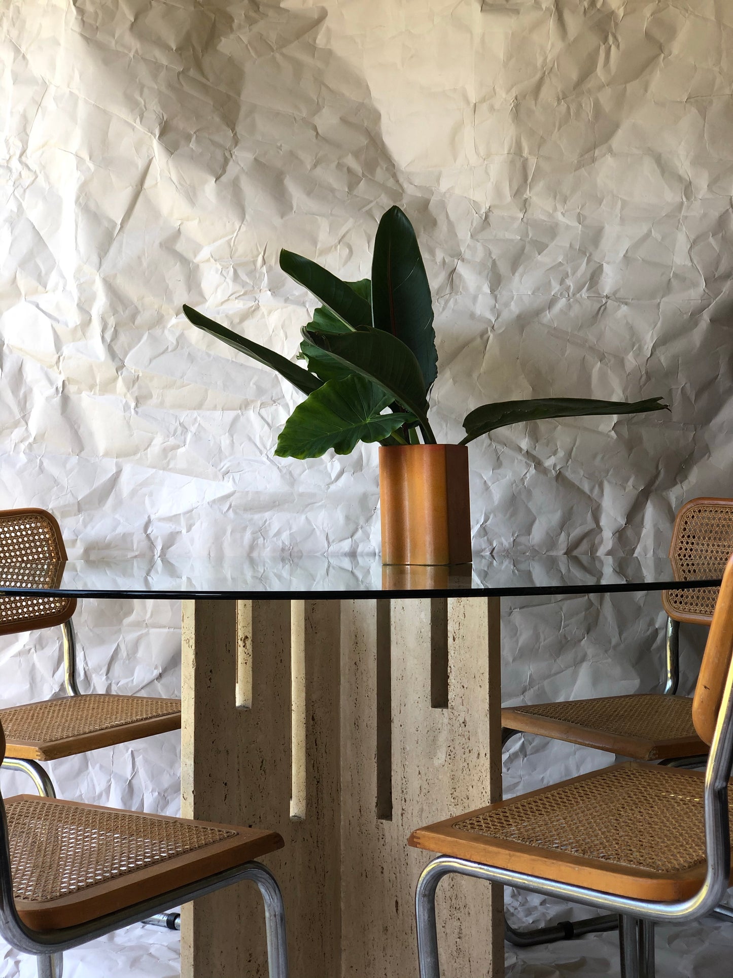Unfilled travertine dining table with glass top