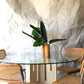 Unfilled travertine dining table with glass top