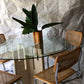 Unfilled travertine dining table with glass top