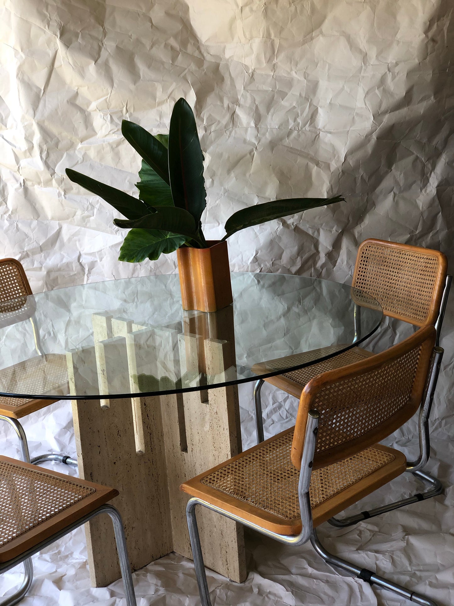 Unfilled travertine dining table with glass top