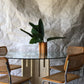 Unfilled travertine dining table with glass top