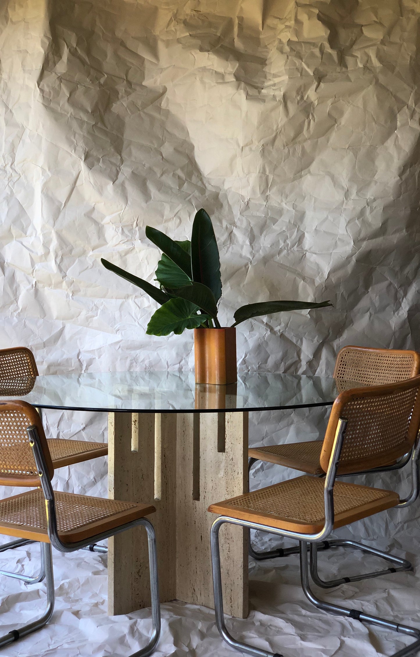 Unfilled travertine dining table with glass top