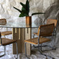 Unfilled travertine dining table with glass top