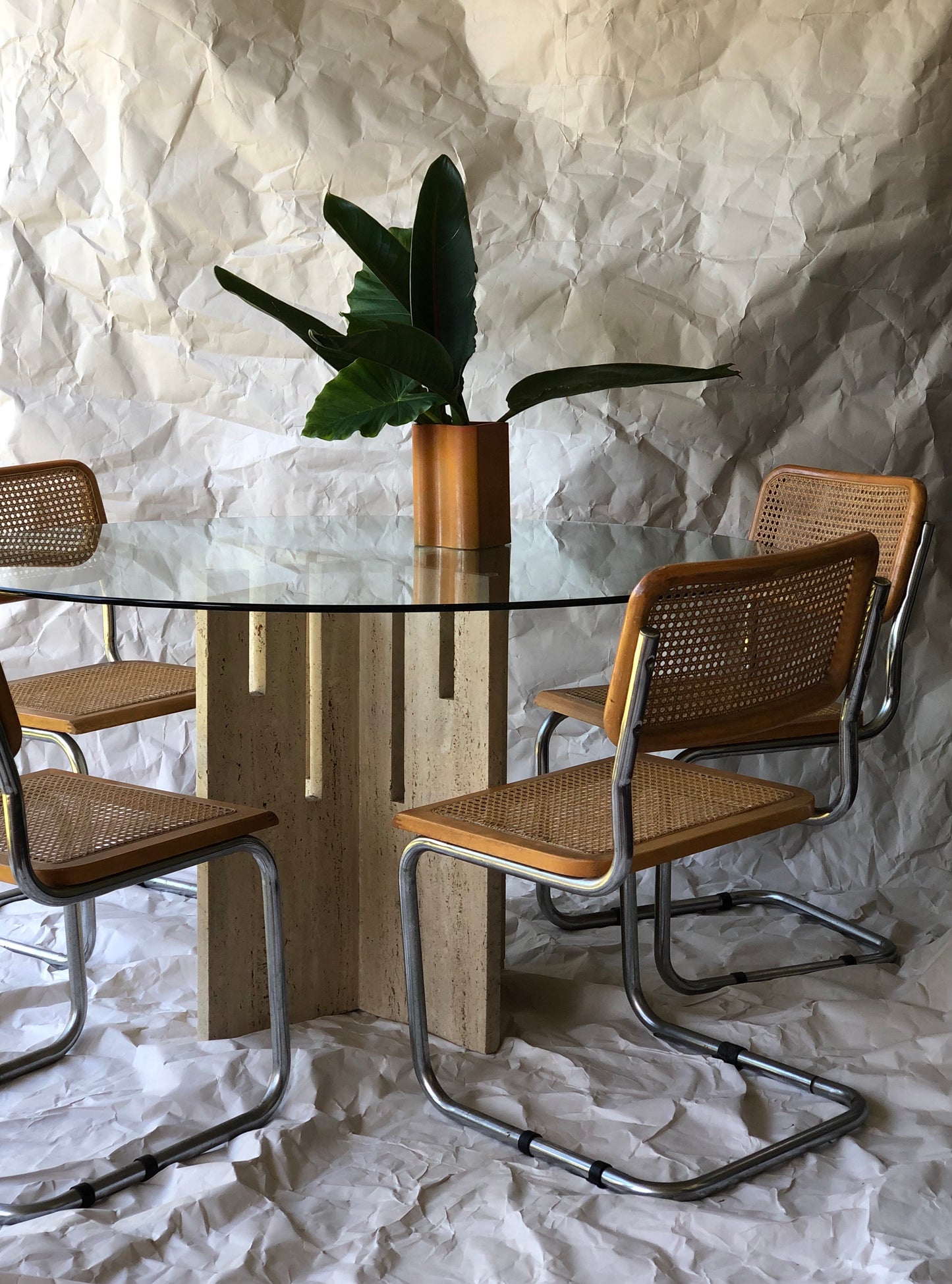 Unfilled travertine dining table with glass top