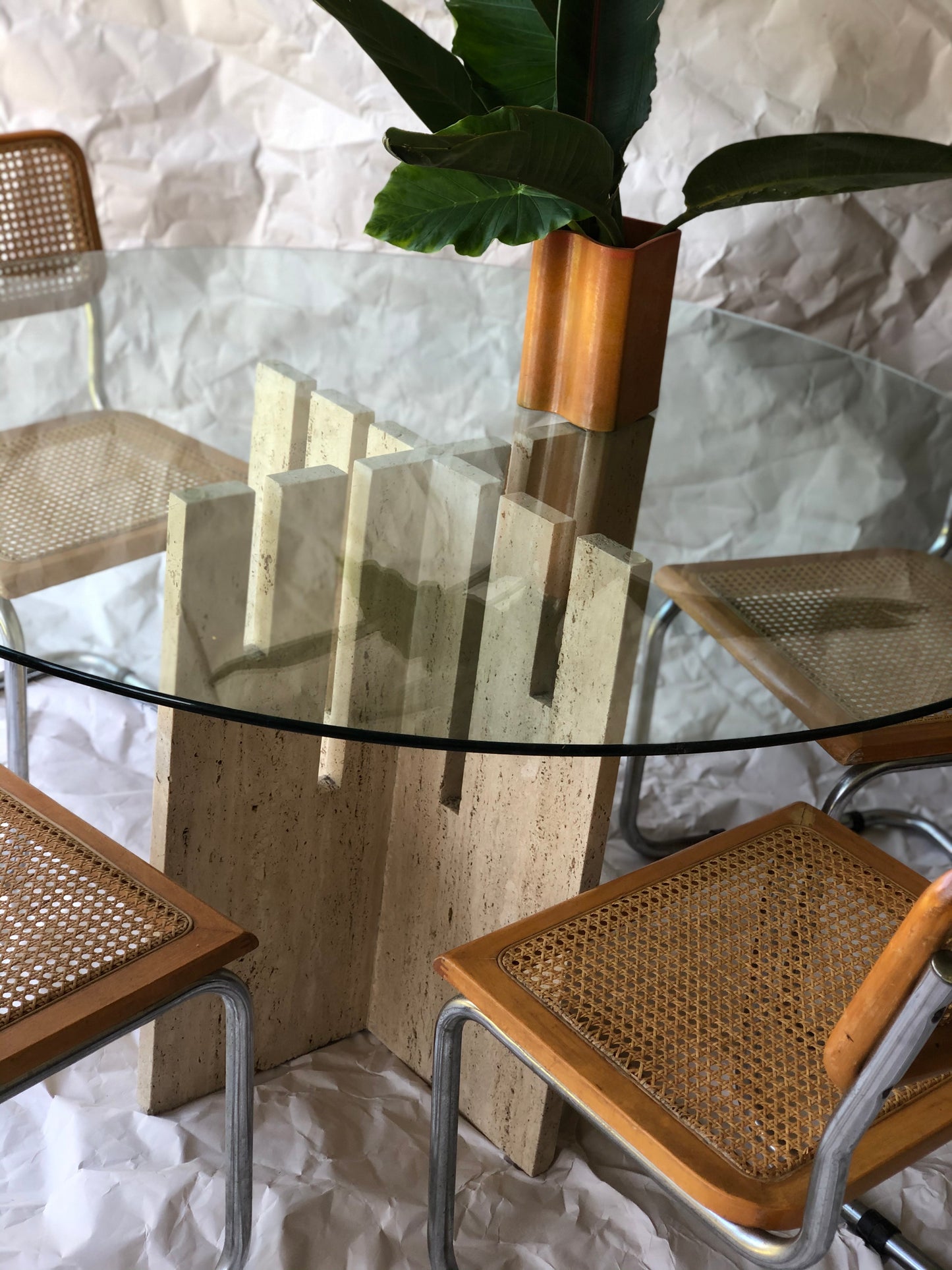Unfilled travertine dining table with glass top