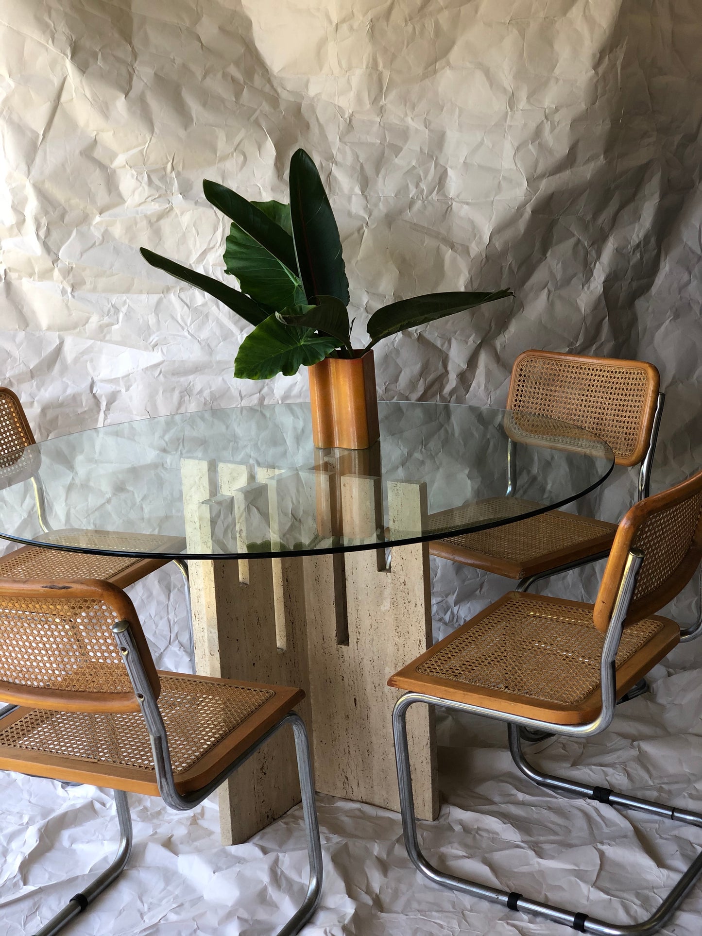 Unfilled travertine dining table with glass top