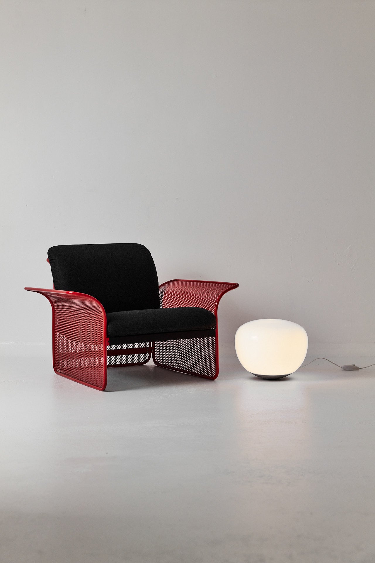 Restored Red perforated steel lounge chair - One available