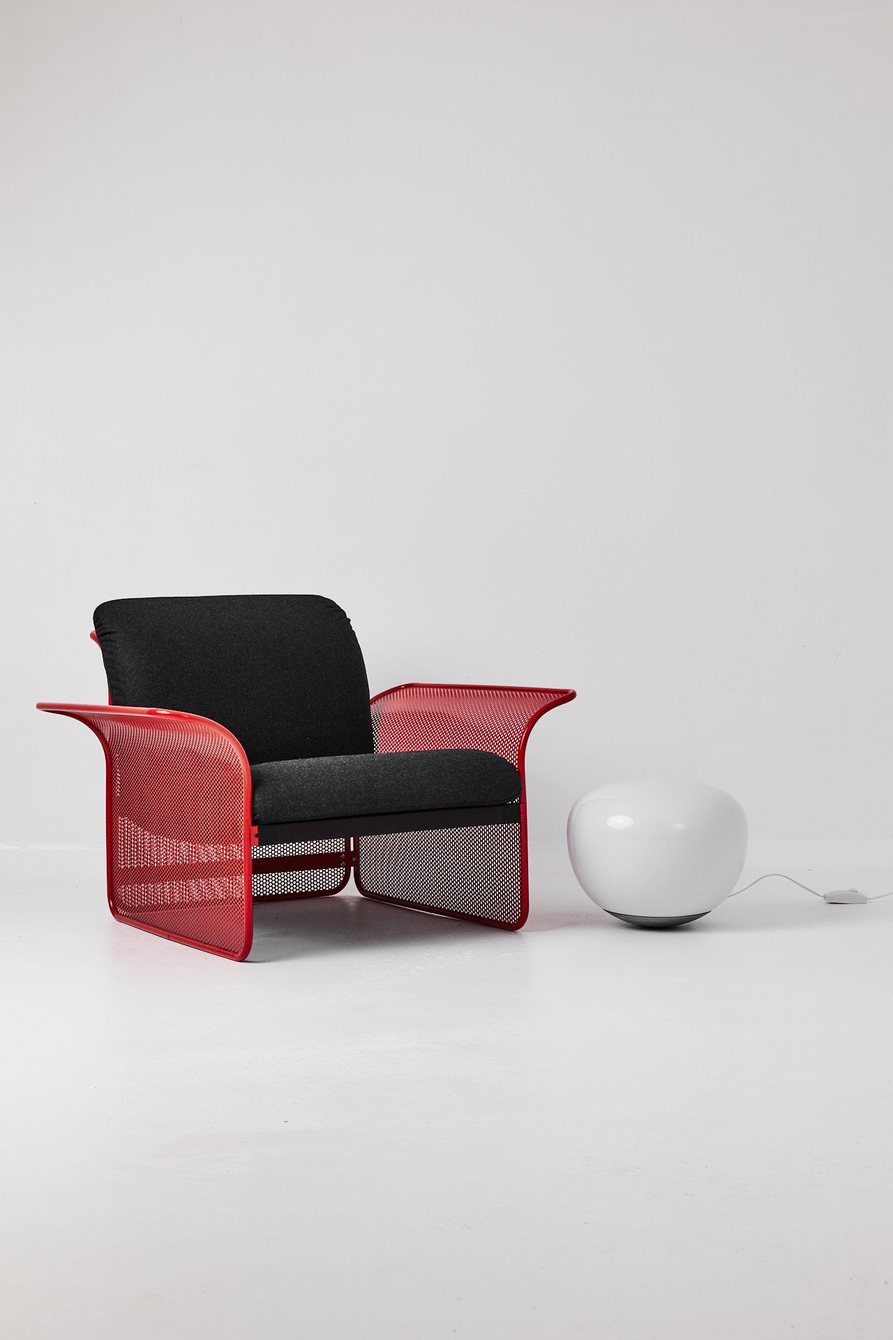 Restored Red perforated steel lounge chair - One available